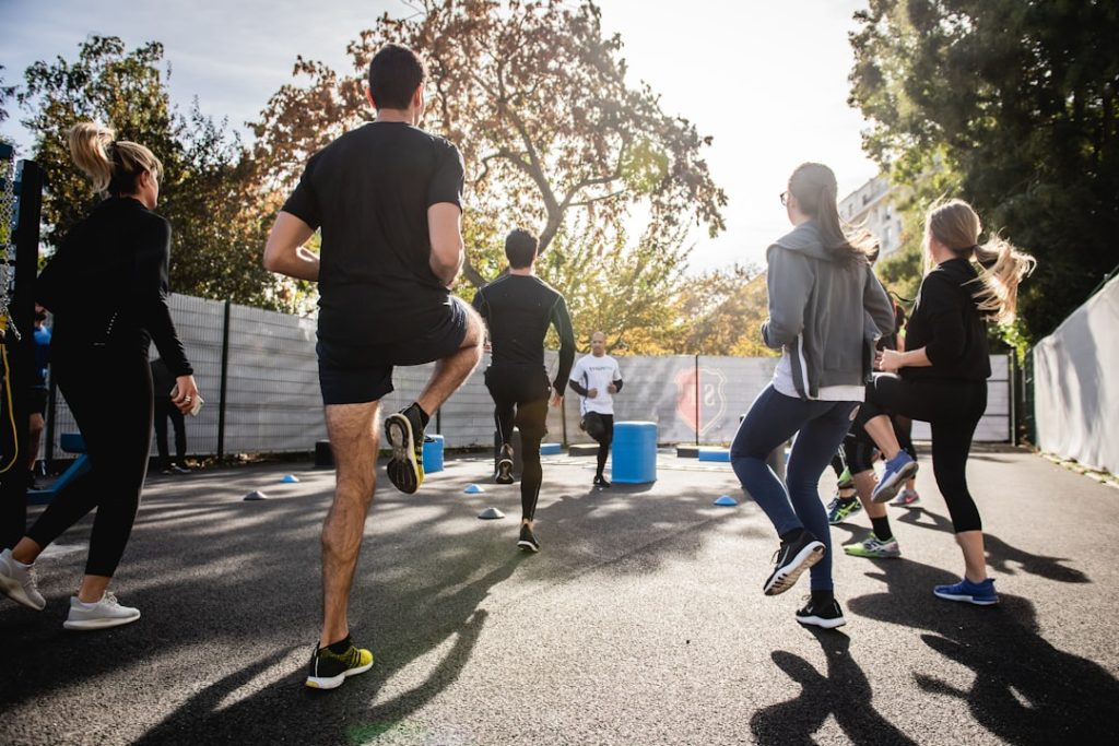 man-in-black-t-shirt-and-black-shorts-running-on-road-during-daytime-j154nekpzlq