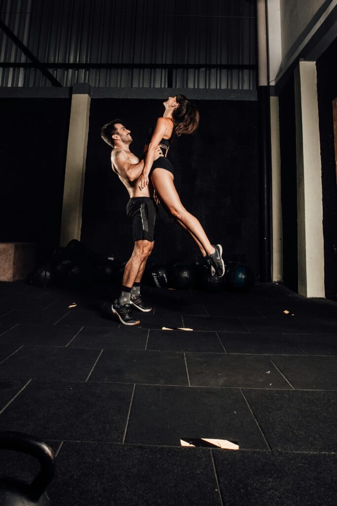 Dynamic workout scene of a couple exercising indoors for fitness and wellness.